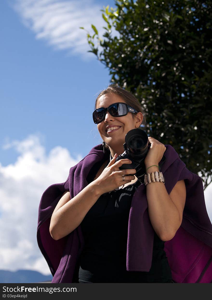 Beautiful girl holding a digital dslr camera