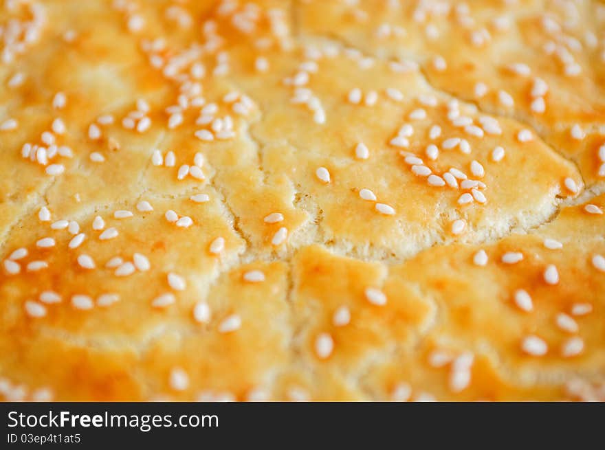 Close up of a crust of bread with sesame seeds