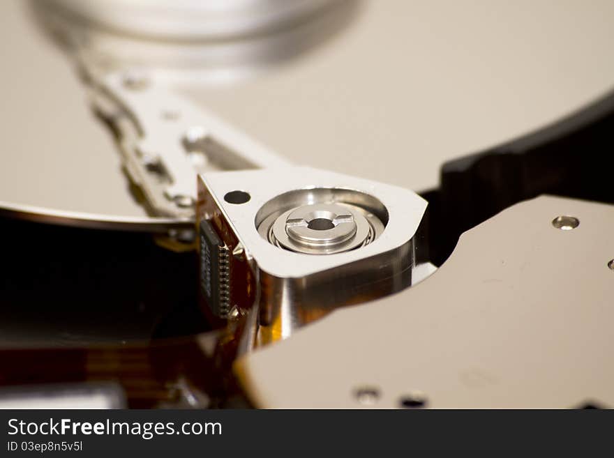 Close up of open hard disk drive, cylinders and heads