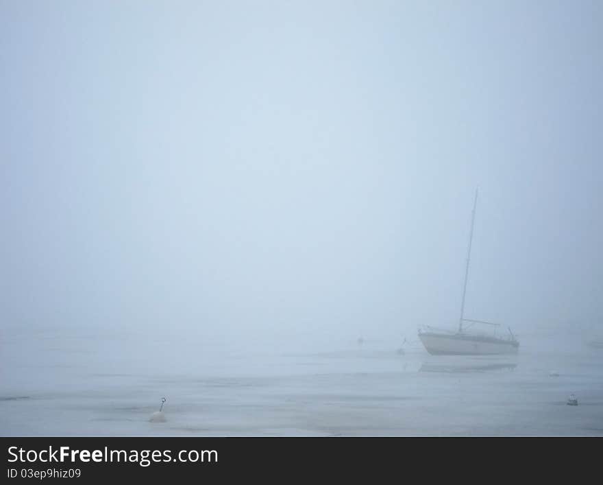 Sailing boat in milky fog