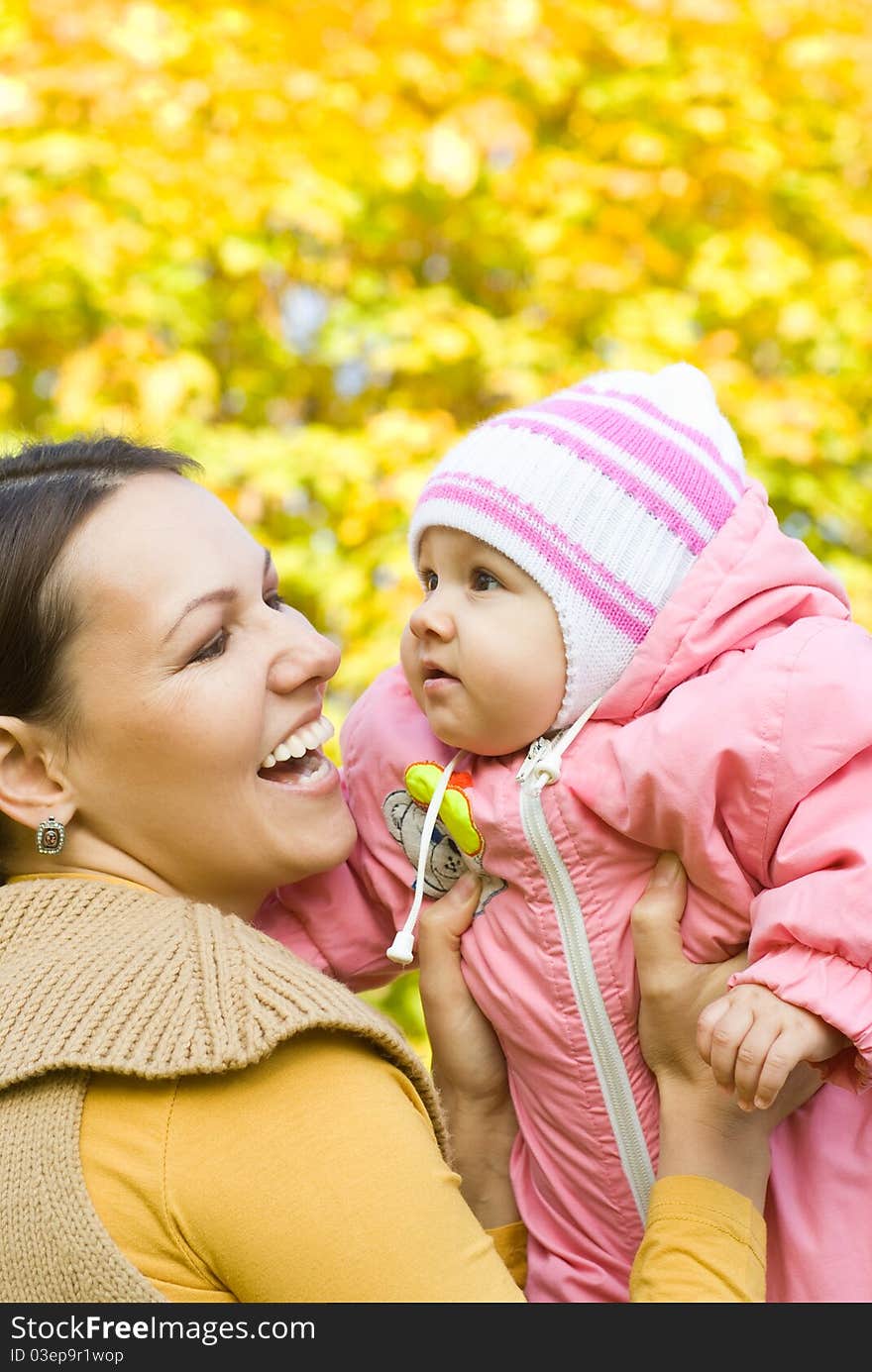 Newborn in the arms of mother nature on the background