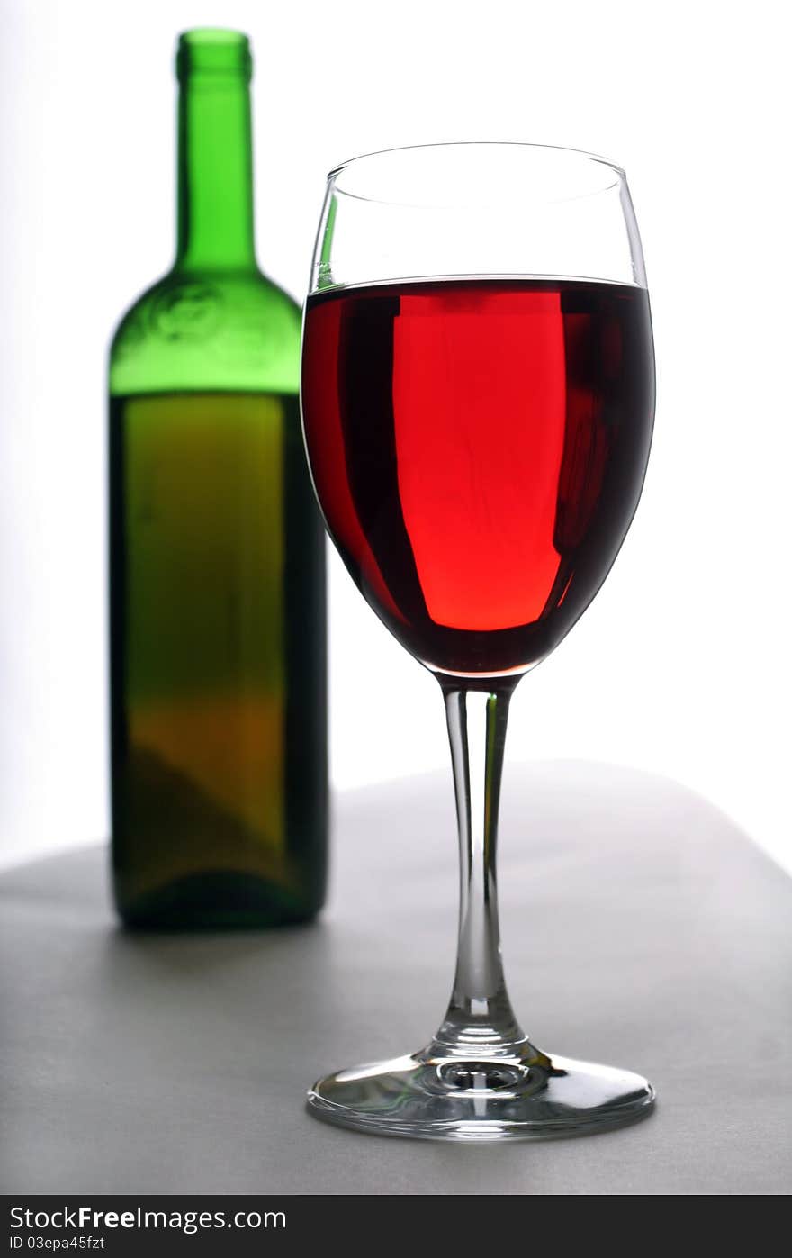 Wineglass and bottle of red wine. Wineglass and bottle of red wine