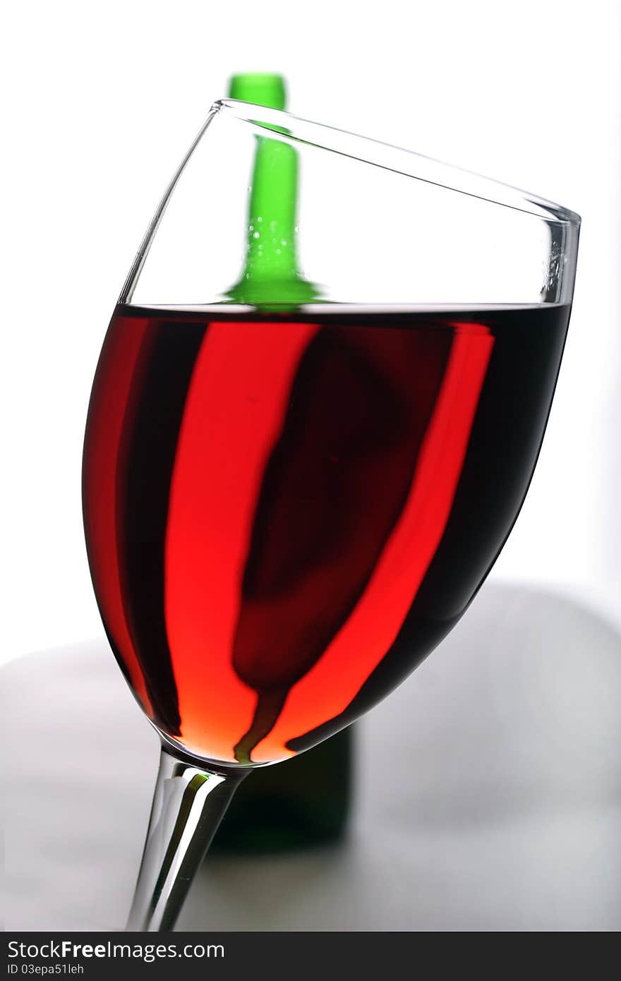 a bottle of red  wine and wineglass. a bottle of red  wine and wineglass