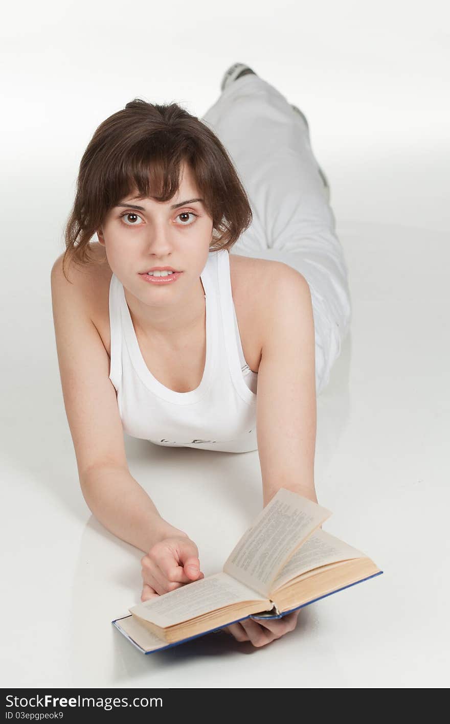 Cute girl with book on the floor