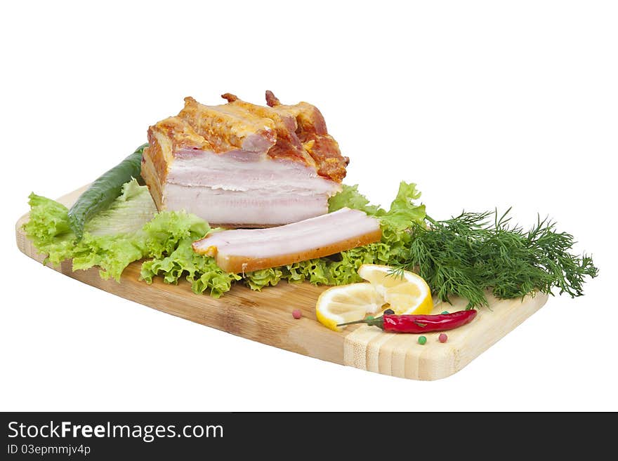 Ham with herbs and spices on a blackboard, isolated on a white background