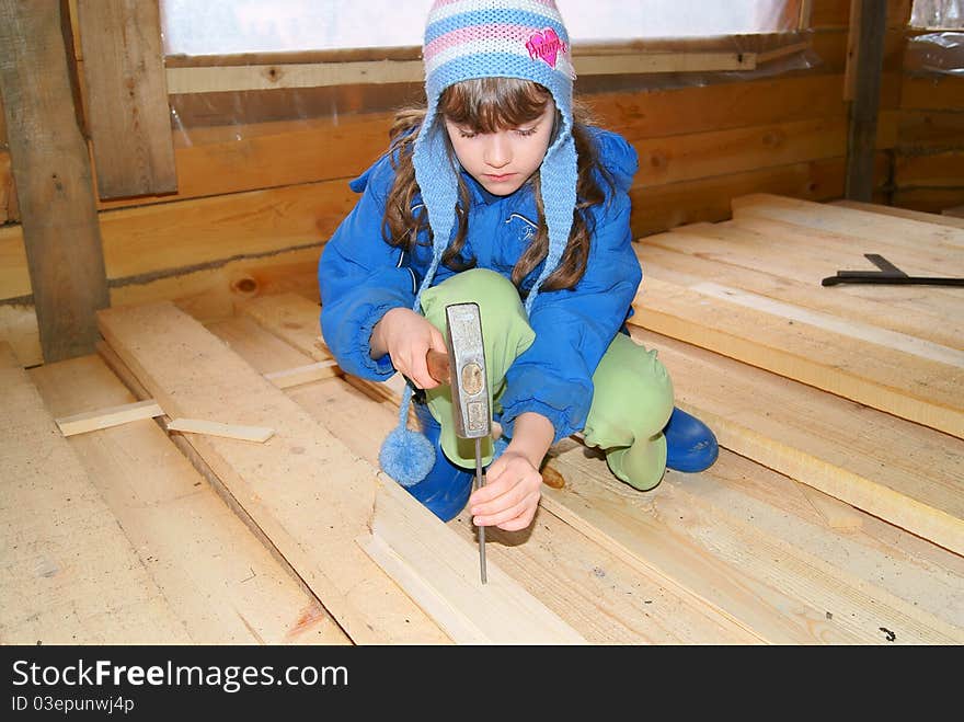 The girl hammers in a nail