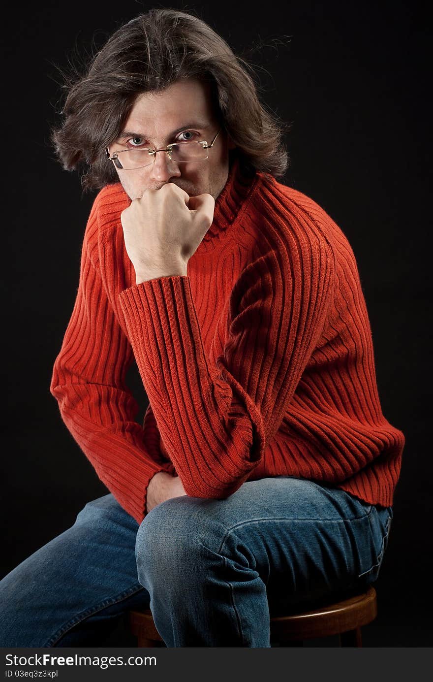 Man in red sweater sitting on chair