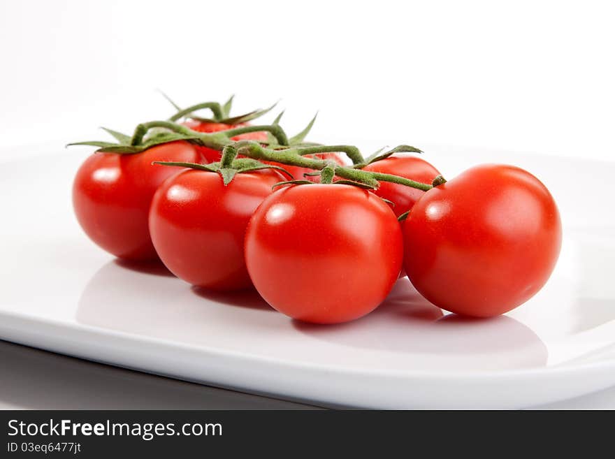 Some tomatos on a plate. Some tomatos on a plate