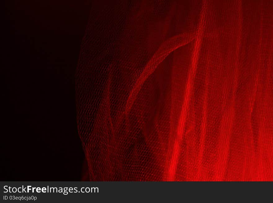 Red light is reflected through the gauze curtain. Red light is reflected through the gauze curtain