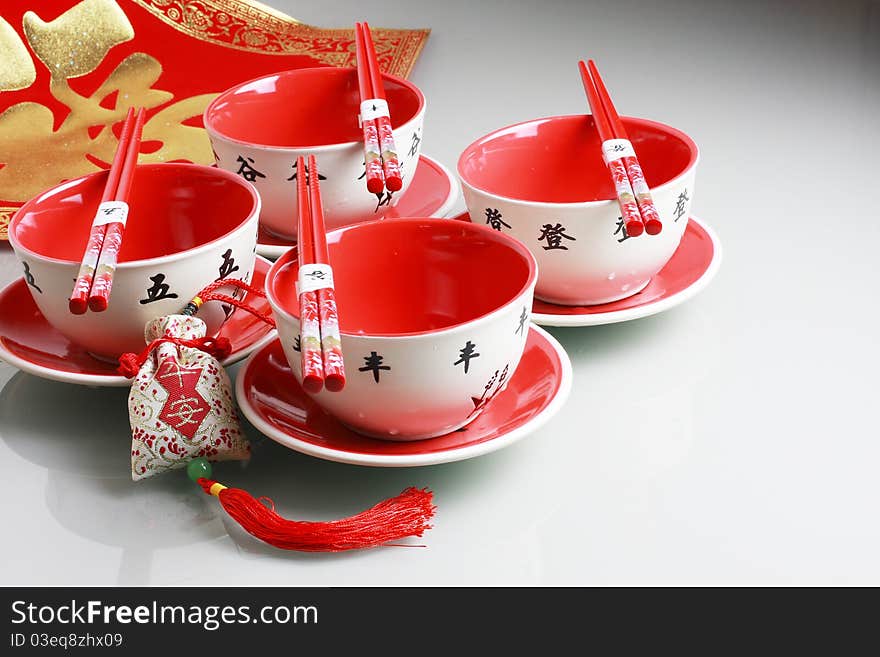 Red bowl,chopsticks and china new yeah wish