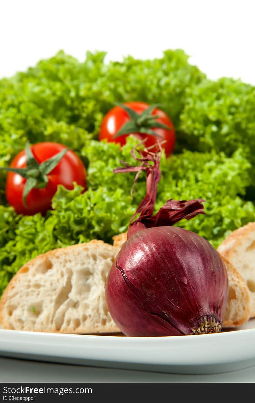 A Onion with a bread slice and salad.