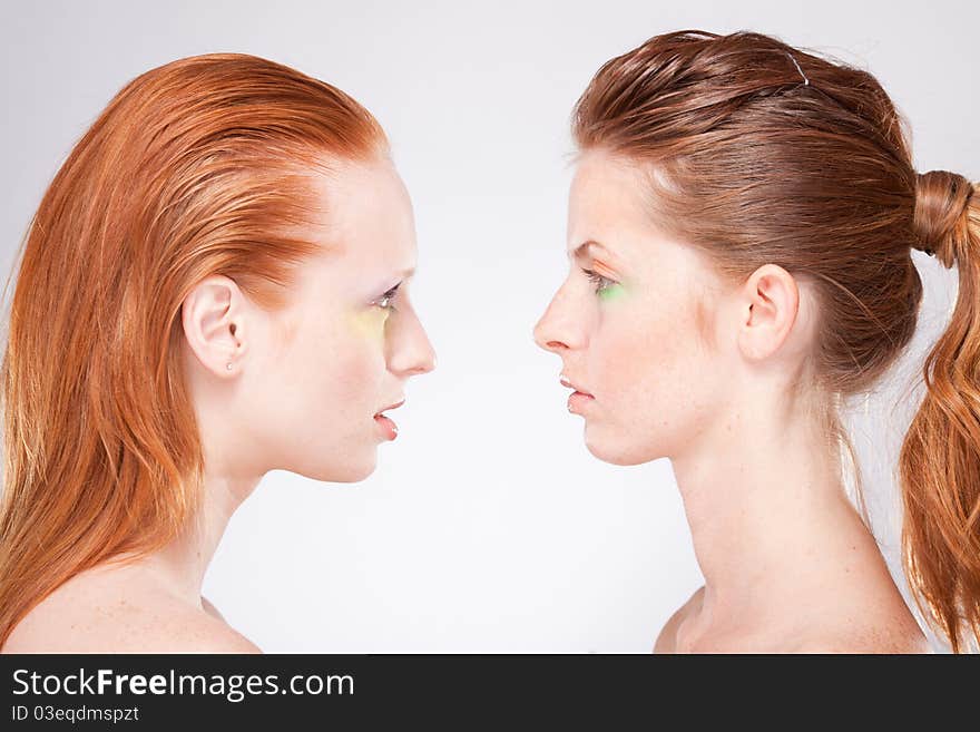 Profile of two red-haired woman