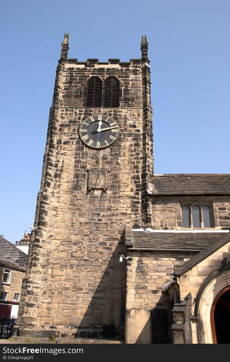 An old Church Clock Tower under a blue spring sky