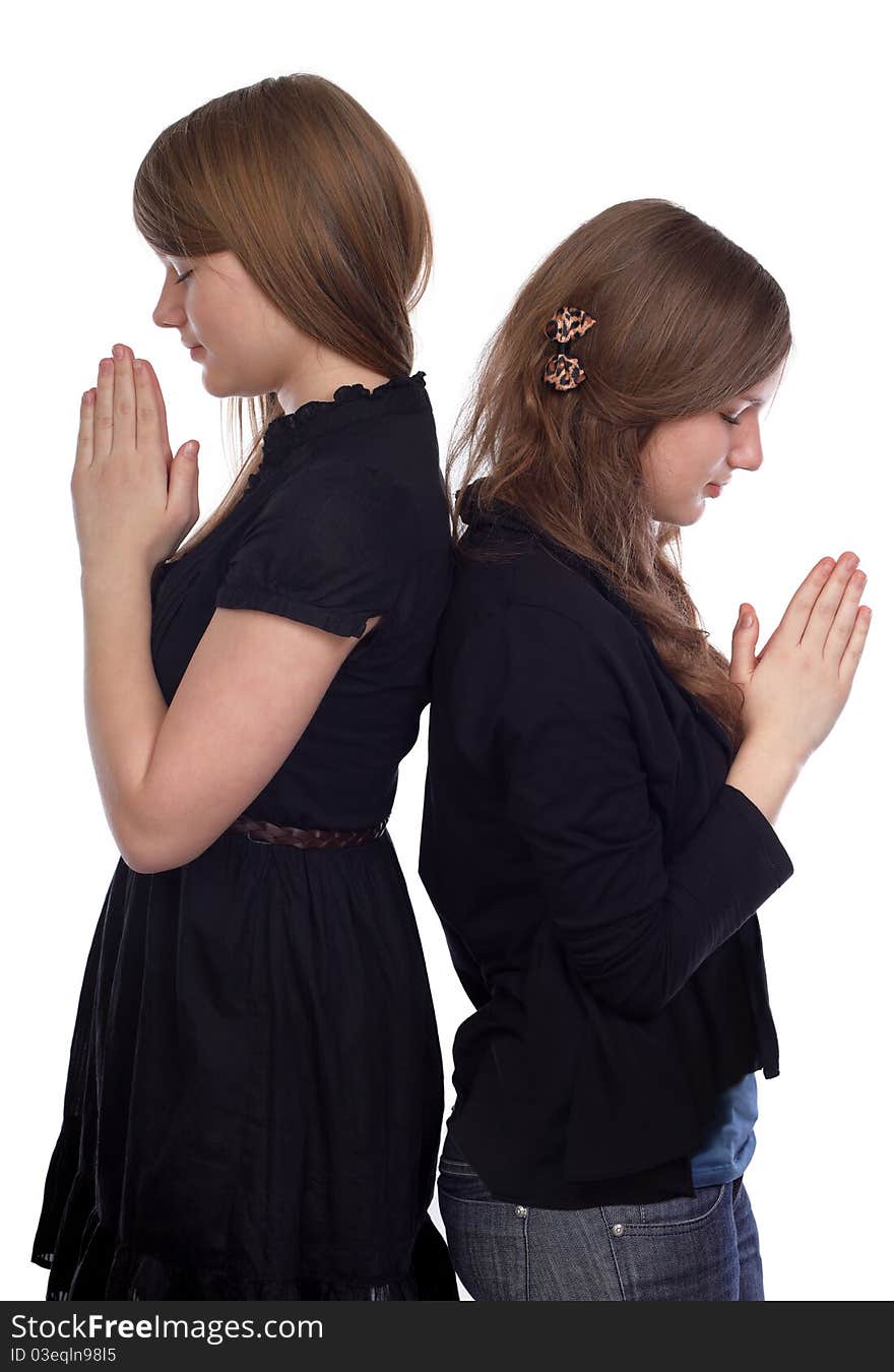 Two girls standing back to back at the time of prayer. Two girls standing back to back at the time of prayer