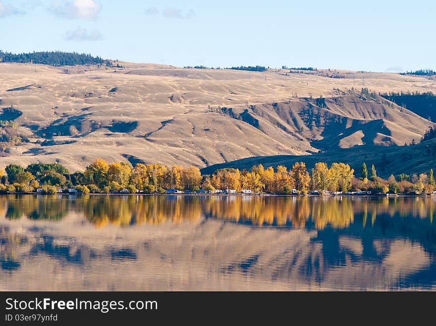 Majestic mountain lake with reflection in water and blue sky. Majestic mountain lake with reflection in water and blue sky.