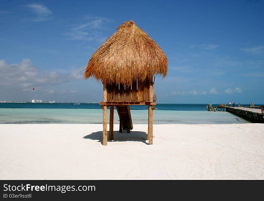 Thatched roof beach hut on white sand beach