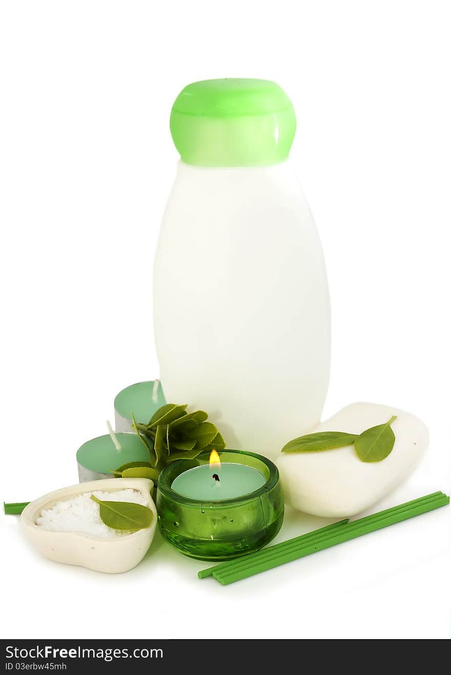 Bottle of shampoo,green leaves and candle. Bottle of shampoo,green leaves and candle