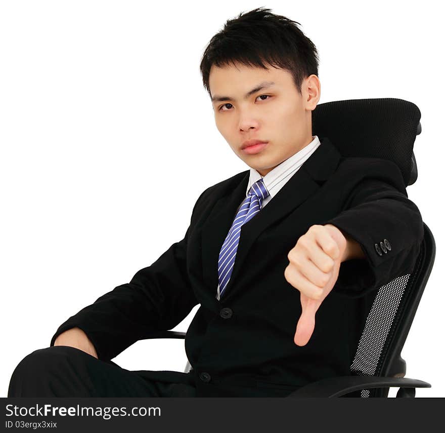 An executive showing thumbs down while sitting on a chair. An executive showing thumbs down while sitting on a chair