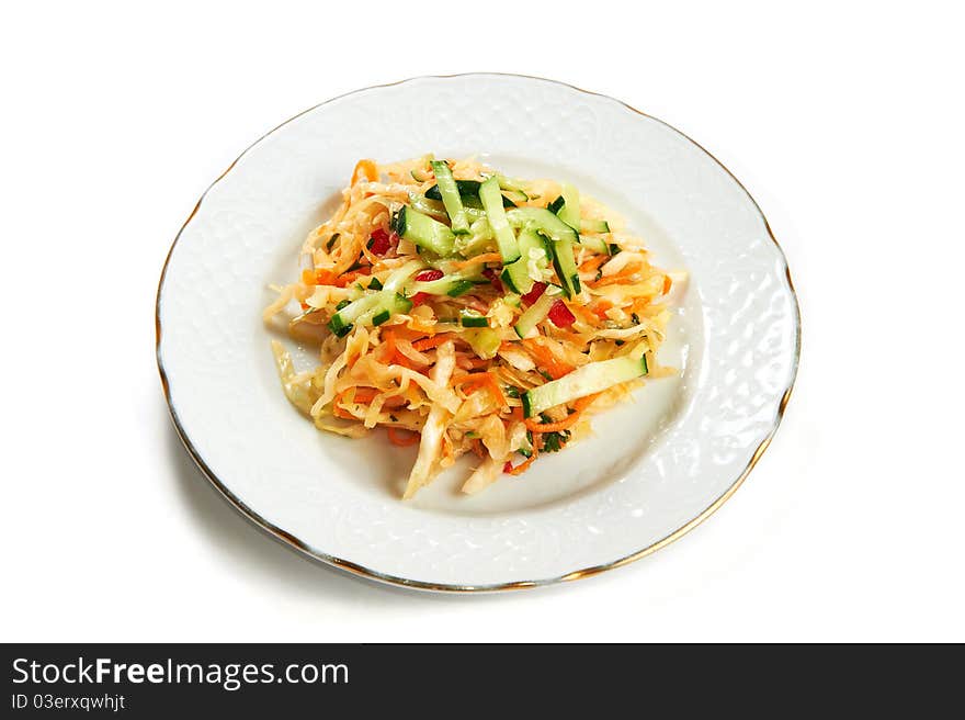 Vitamin salad of cabbage, carrots, cucumber and pepper isolated on white background. Vitamin salad of cabbage, carrots, cucumber and pepper isolated on white background