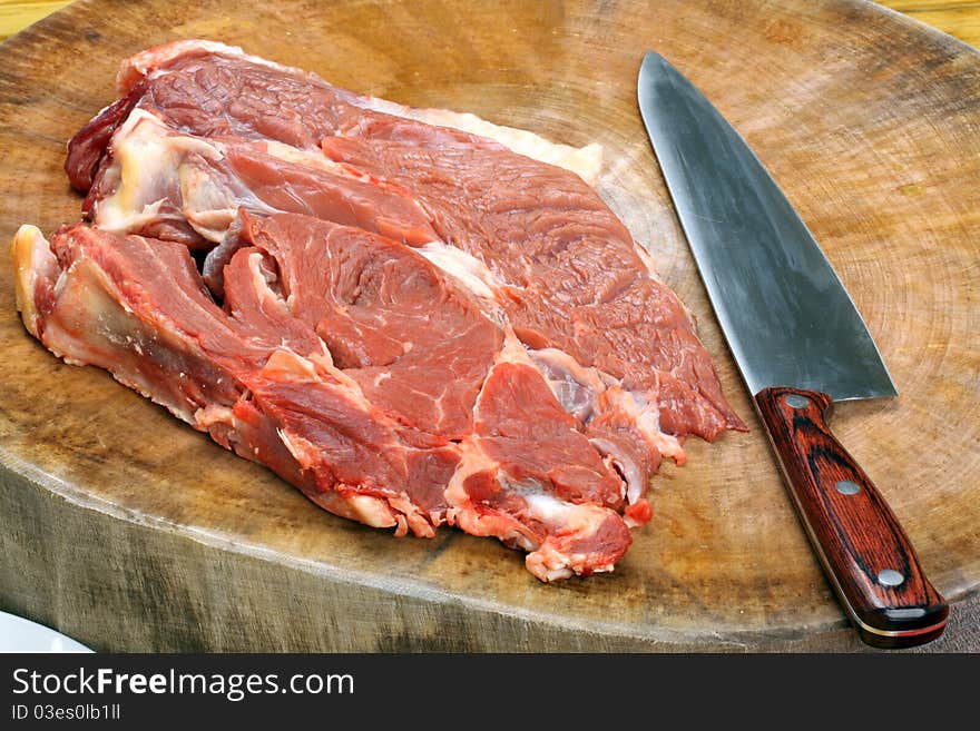 Raw pork and knife on Chopping board