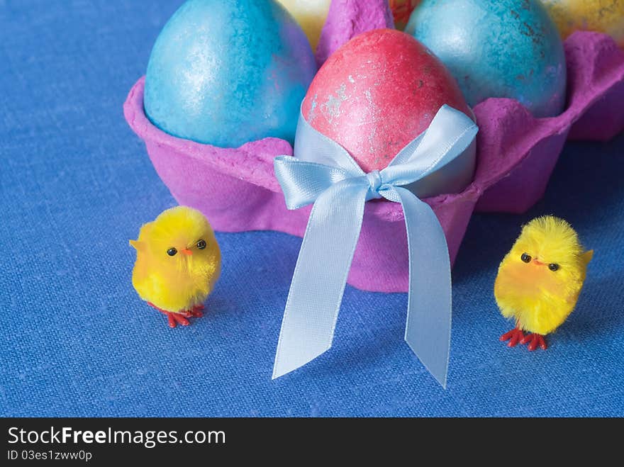 Easter: box with multicolored eggs and funny chicken. Easter: box with multicolored eggs and funny chicken.