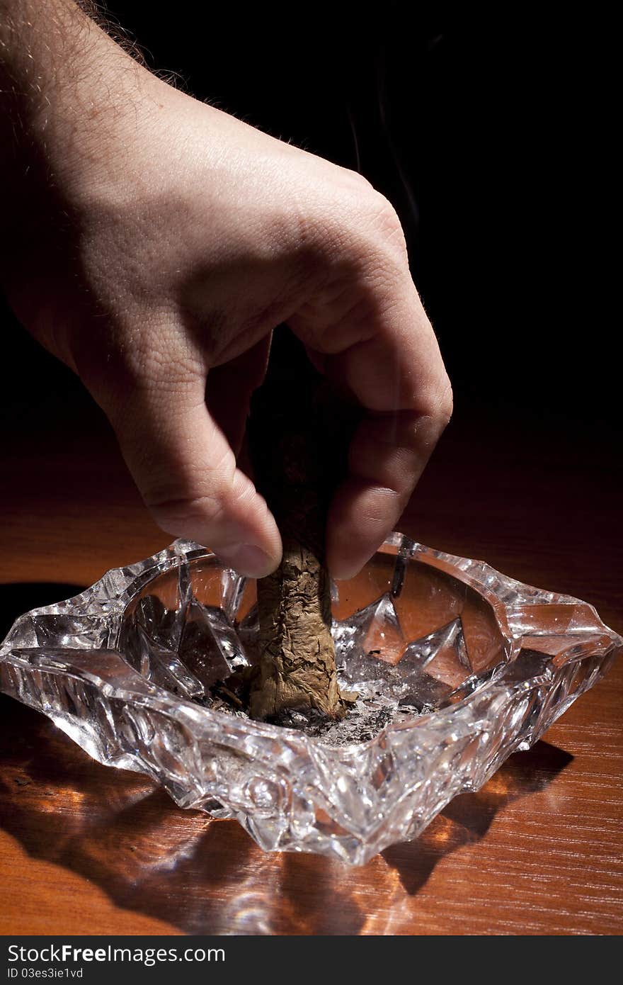 Smoking cigar from cuba over black background