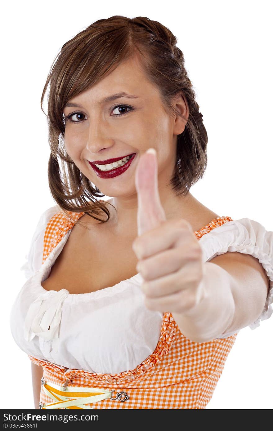 Happy Bavarian woman in Oktoberfest dirndl shows thumb up. Isolated on white background.