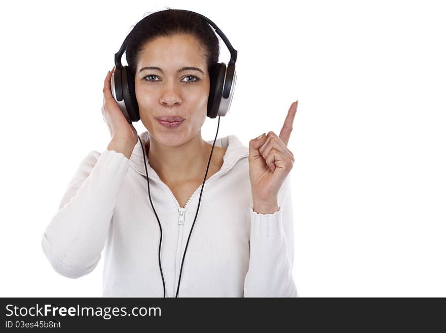 Woman with headphones listening to mp3 music and points with finger. Isolated on white background.