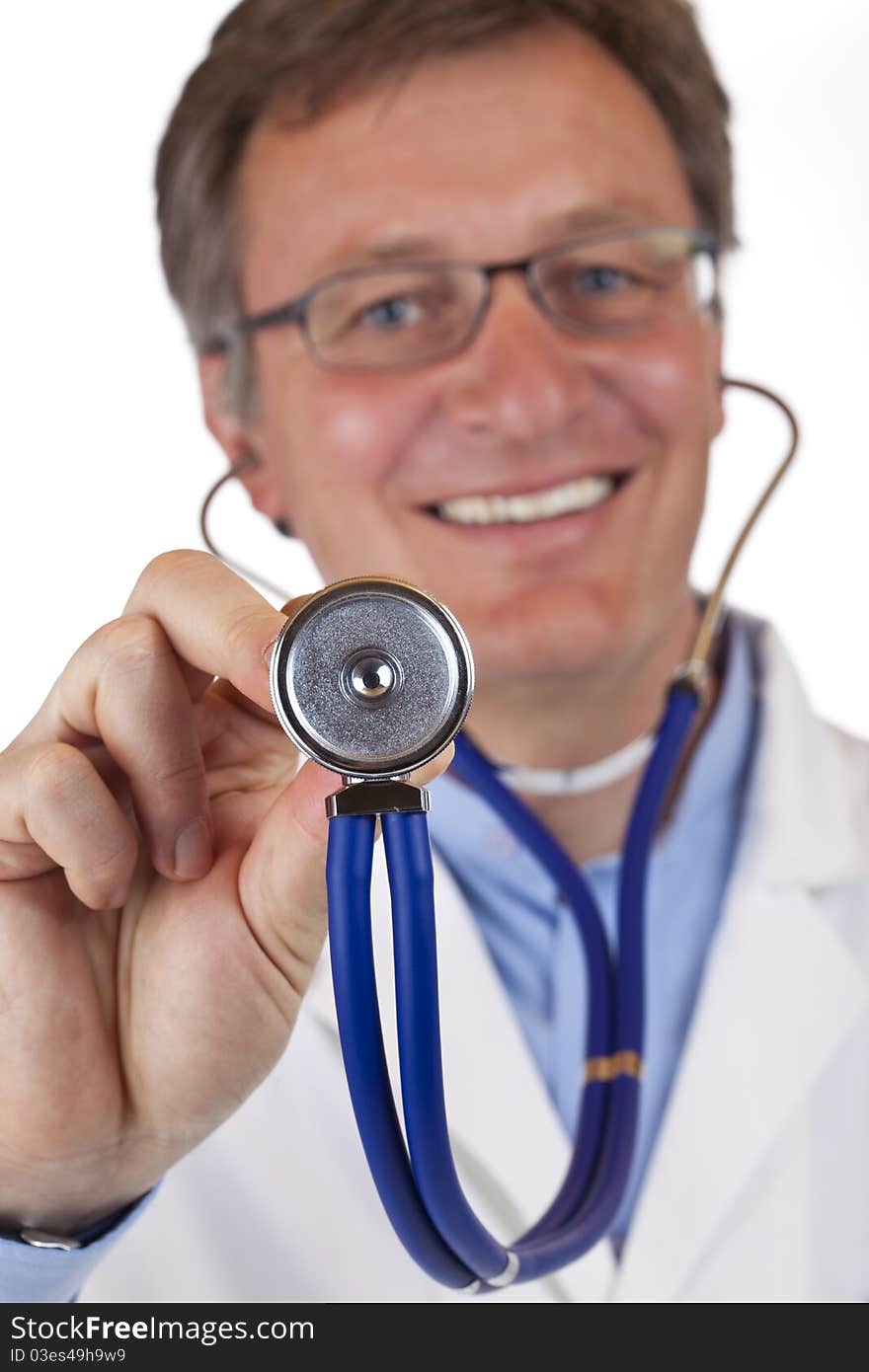 Close-up of a stethoscope,in background the smiling doctor.Isolated on white background. Close-up of a stethoscope,in background the smiling doctor.Isolated on white background.