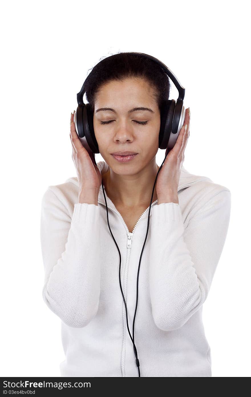 Attractive, young woman with headphones listens relaxed to music. Isolated on white background. Attractive, young woman with headphones listens relaxed to music. Isolated on white background.