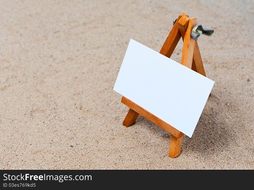 Easel in the sand with blank canvas