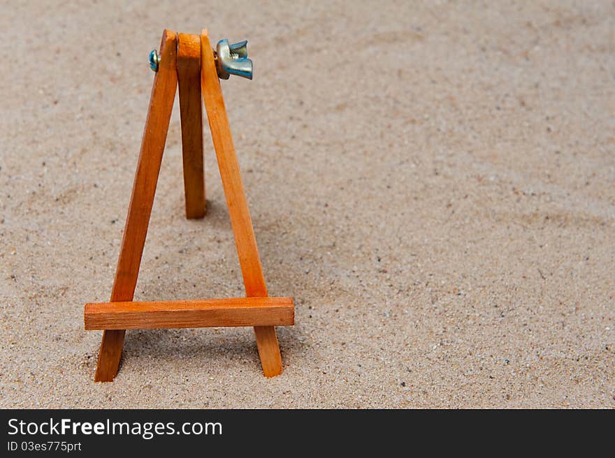 Empty easel in the sand