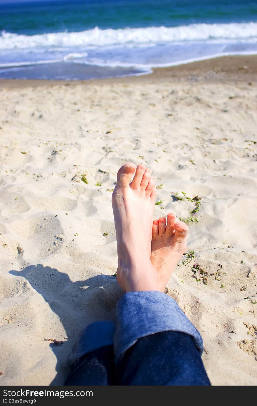 Girl's feet on the background of the sea. Girl's feet on the background of the sea