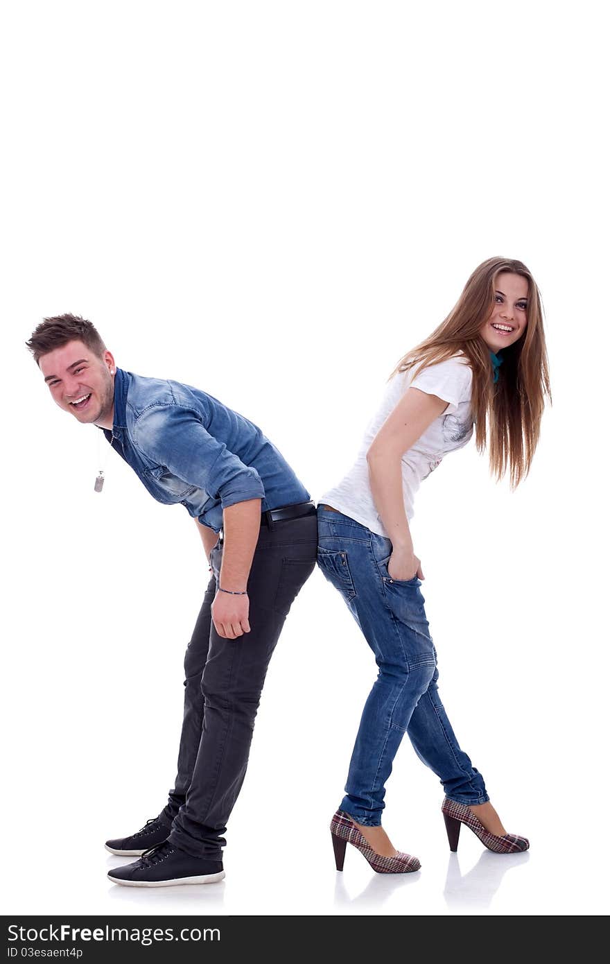 Portrait of a happy young couple, laughing and standing back to back on white background. Portrait of a happy young couple, laughing and standing back to back on white background