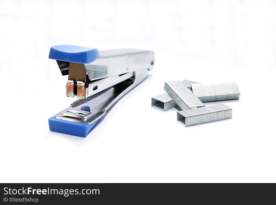 Isolated blue stapler and staples on white