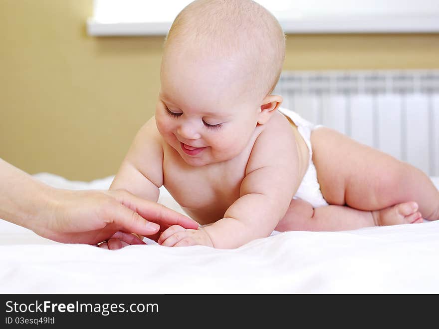 Happy  baby girl on bed. Happy  baby girl on bed.