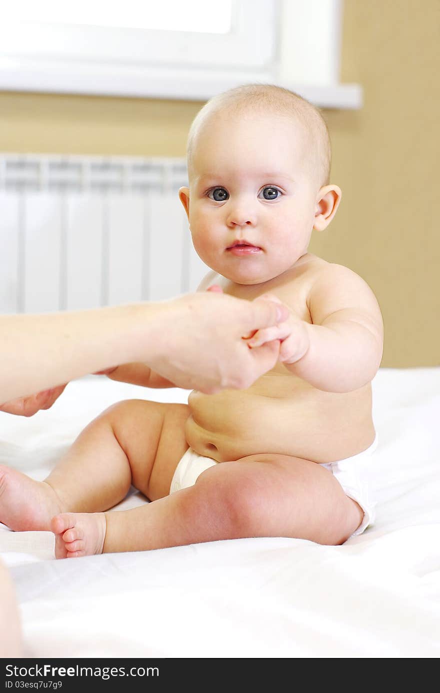 Happy  baby girl on bed. Happy  baby girl on bed.