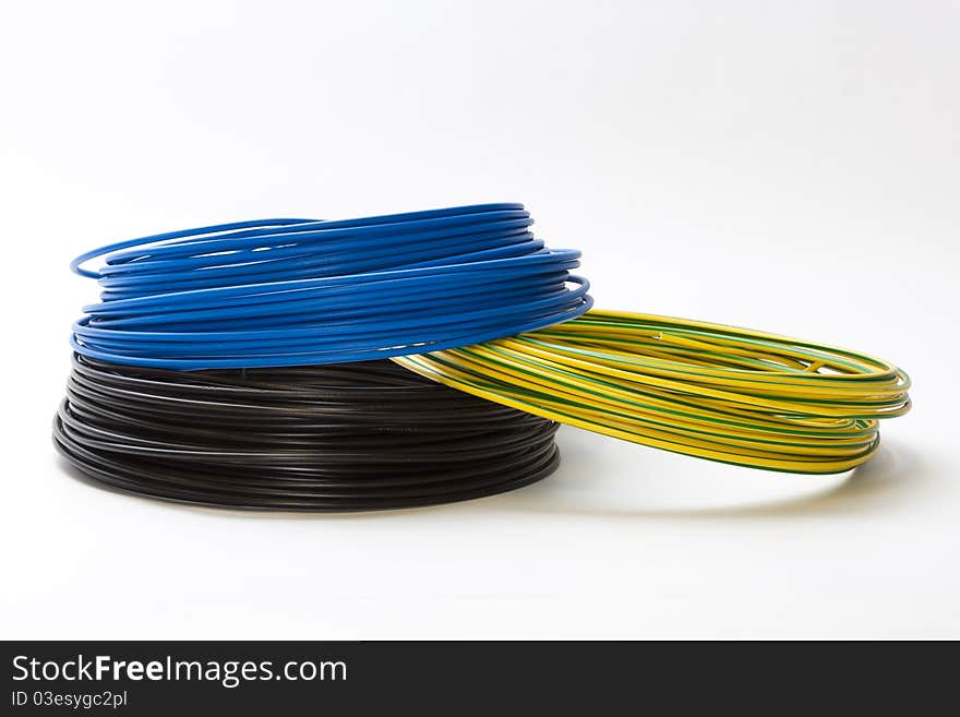 Single electric cables in blue, black an green-yellow. Single electric cables in blue, black an green-yellow