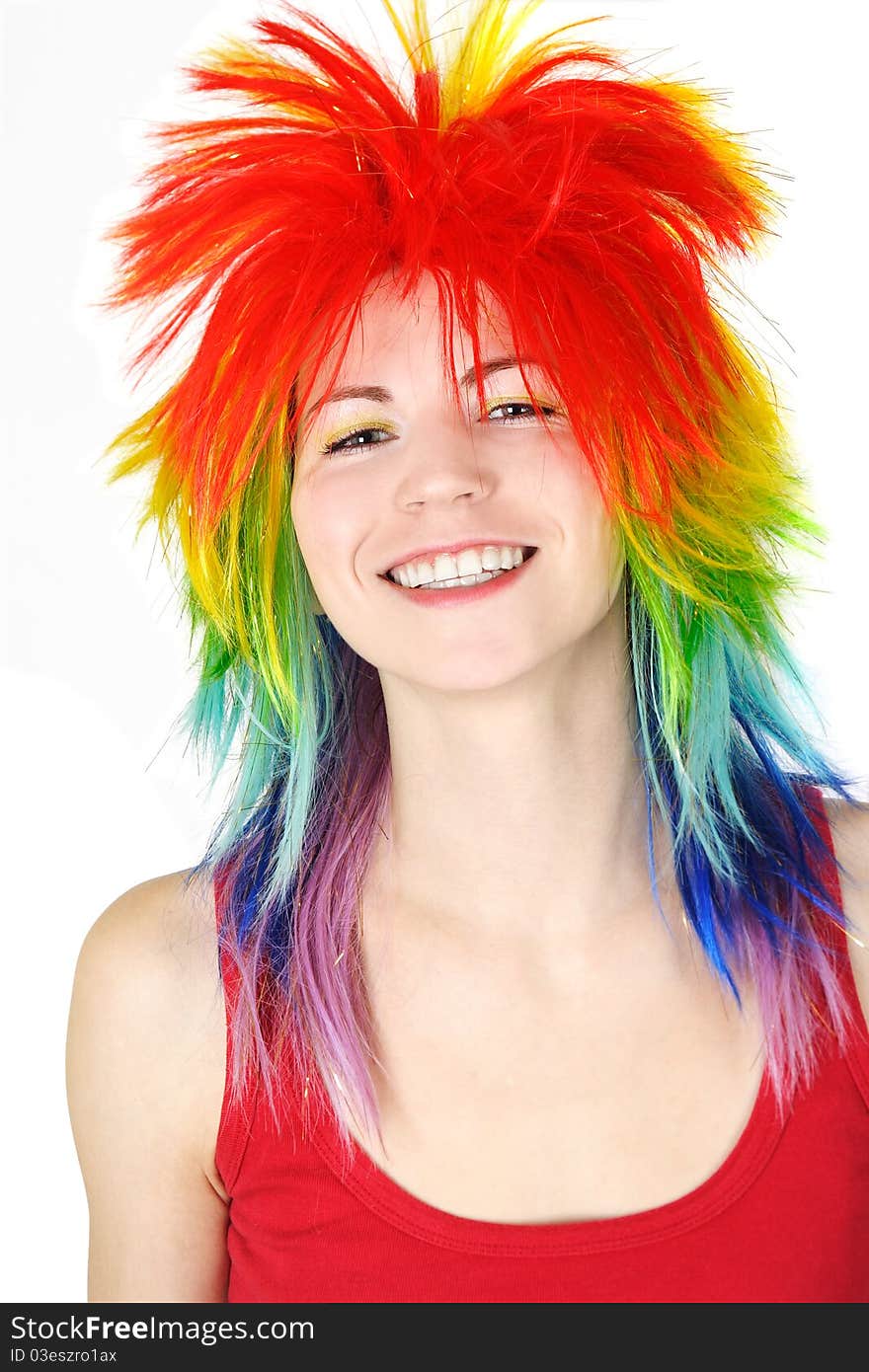 Young beauty woman in multicolored clown wig smiling, isolated