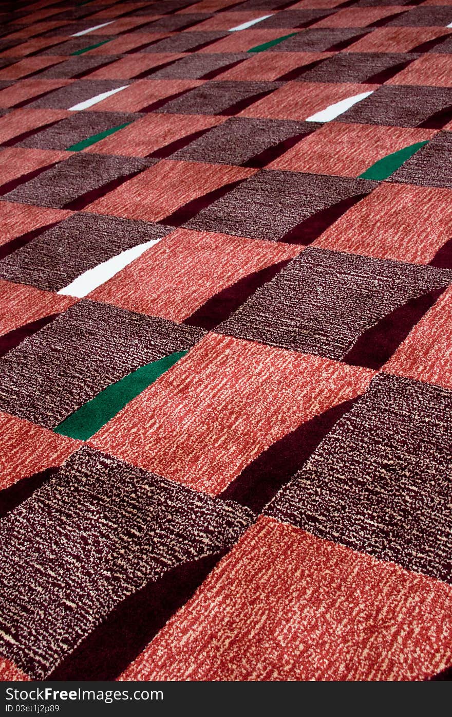 A square design of carpet in a theatre room for sound absorption