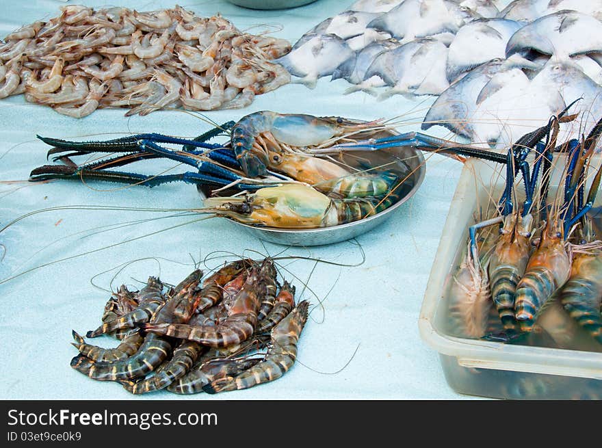 A display of fresh water prawn and white pomfret in a wet market. A display of fresh water prawn and white pomfret in a wet market