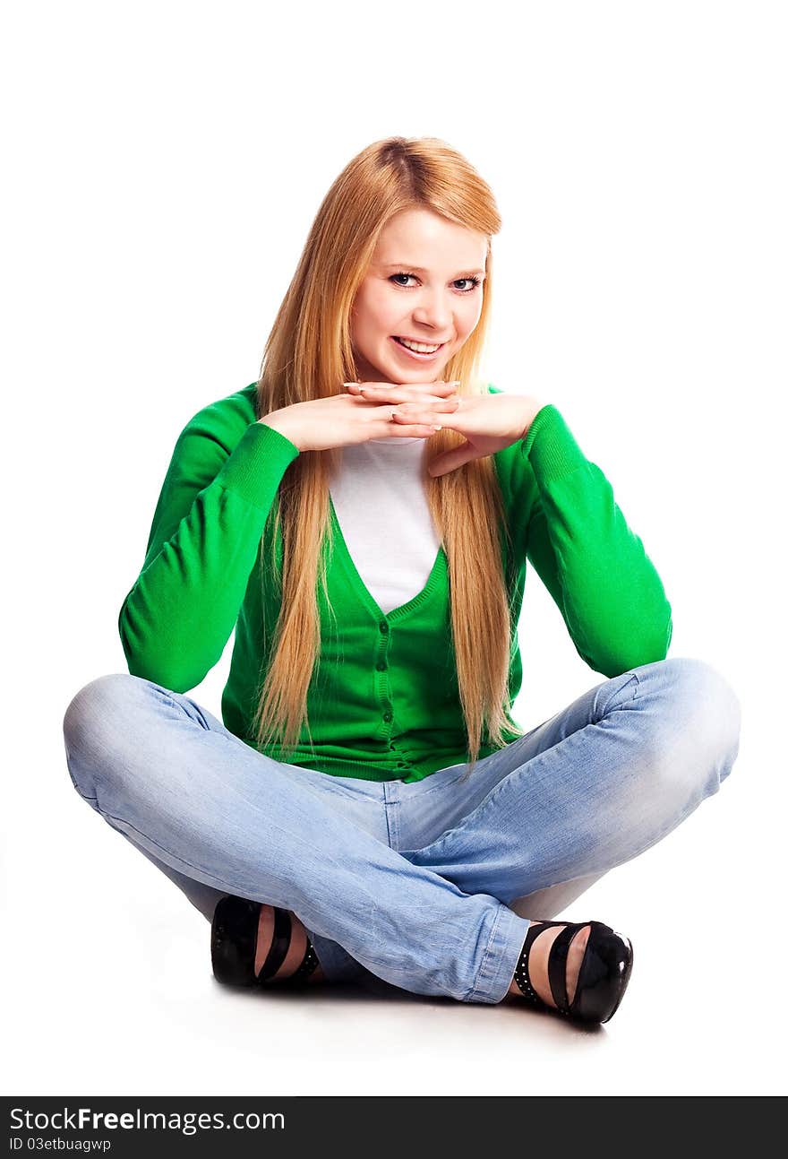 Beautiful  young  woman sitting on the floor against white background. Beautiful  young  woman sitting on the floor against white background