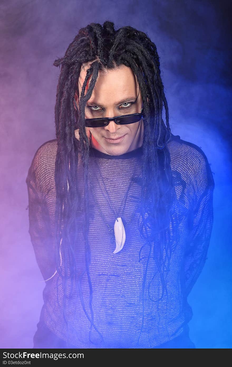 Portrait of a heavy metal musician. Shot in a studio. Portrait of a heavy metal musician. Shot in a studio.