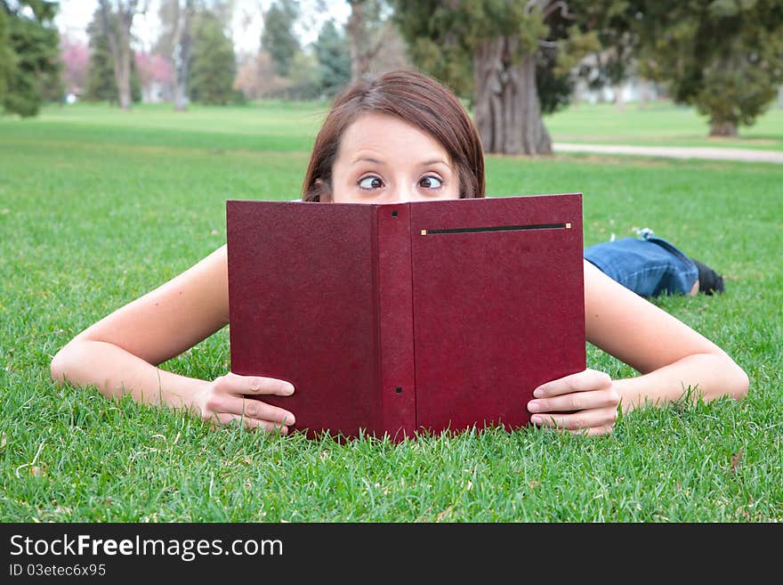 Young student with crossed eyes reading. Young student with crossed eyes reading