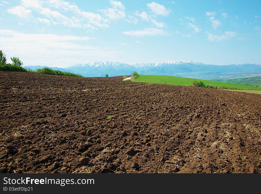 The fresh plowed field in mountains. The fresh plowed field in mountains