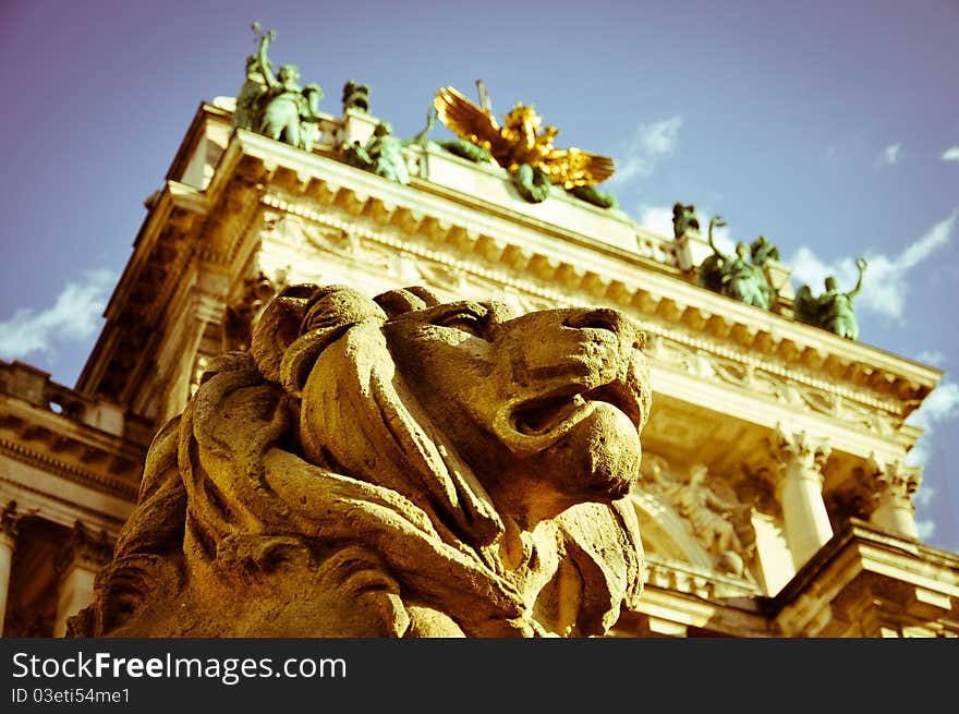 Stone lion sculpture guarding vienna's national library with vintage effects. Stone lion sculpture guarding vienna's national library with vintage effects