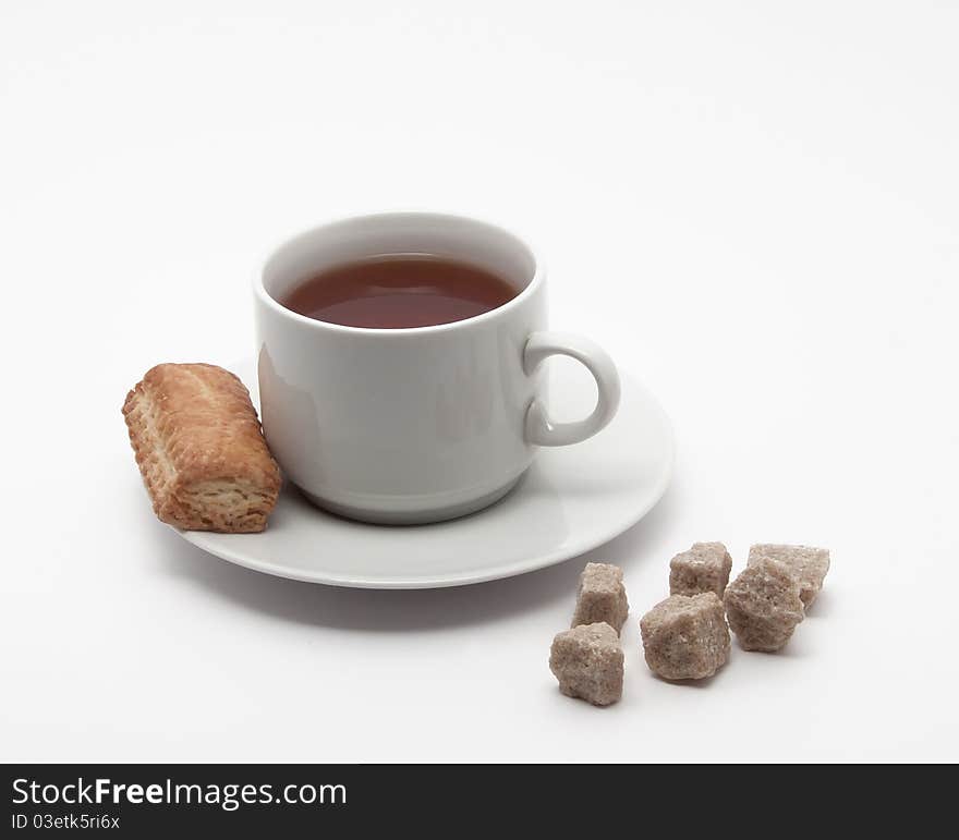 Full cup of tea on a saucer with cookies. Full cup of tea on a saucer with cookies