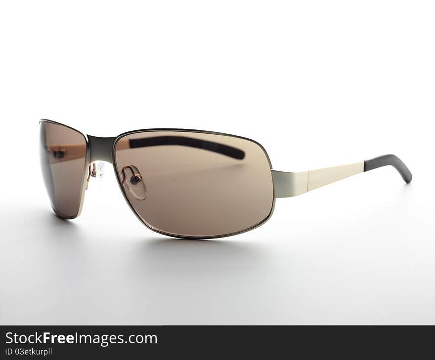 Beautiful brown sunglases on the white background. Beautiful brown sunglases on the white background