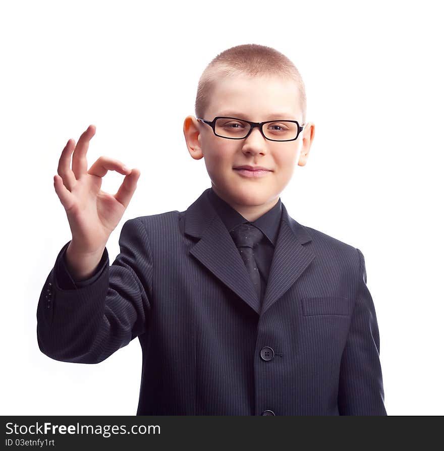 Young ten year old businessman showing the sign OK. Young ten year old businessman showing the sign OK