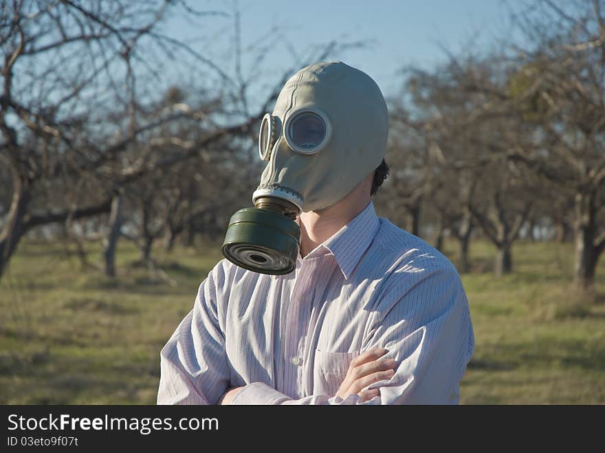 Man in the Gas Mask surrounded by leafless trees.